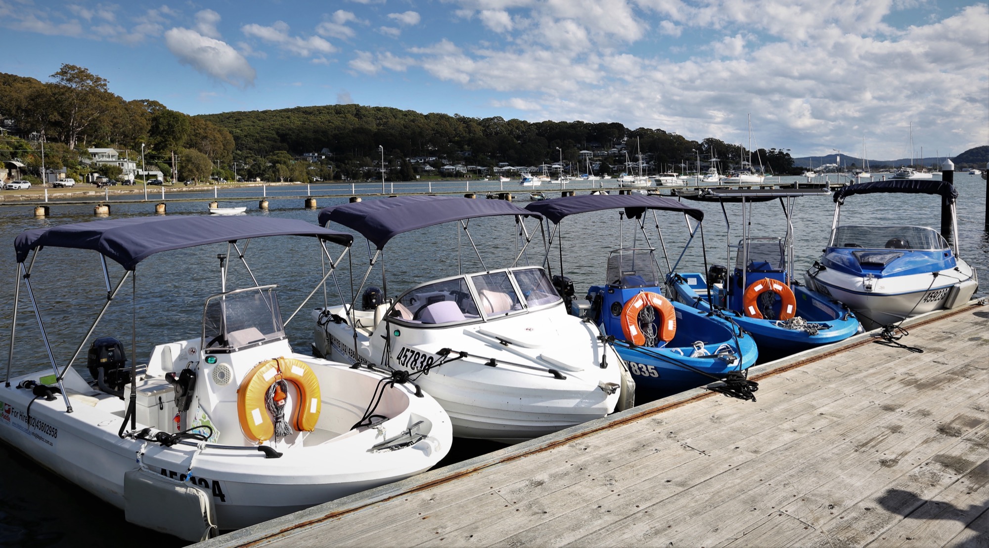 The hire fleet moored along the jetty at Hardys Bay